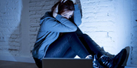 Woman against wall looking scared